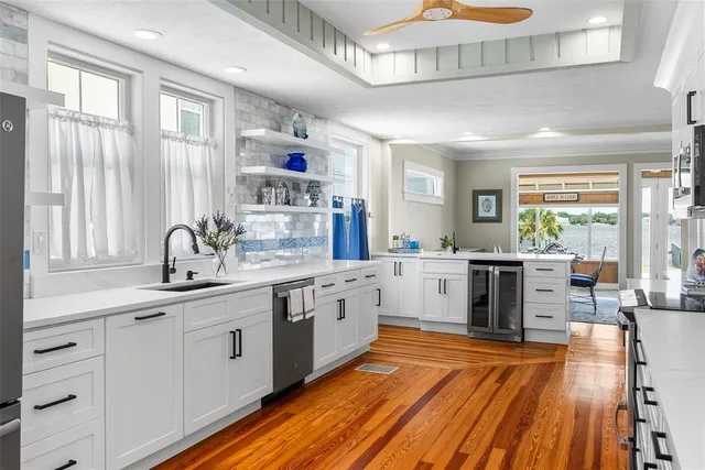 a living room with furniture a rug and a large window