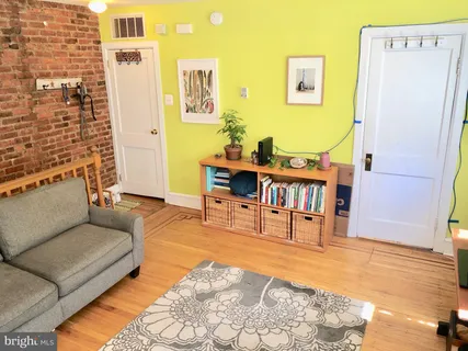 a living room with furniture a dining table and a rug