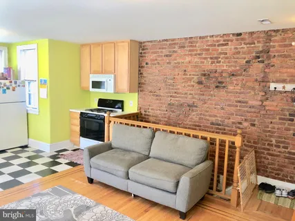 a living room with a couch next to a window