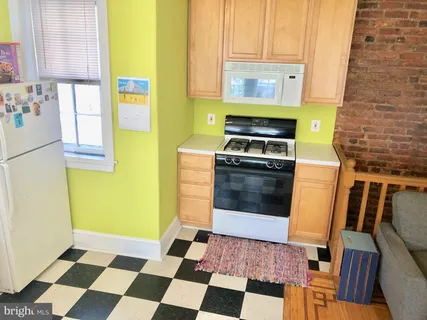 a kitchen with a stove a sink and a microwave