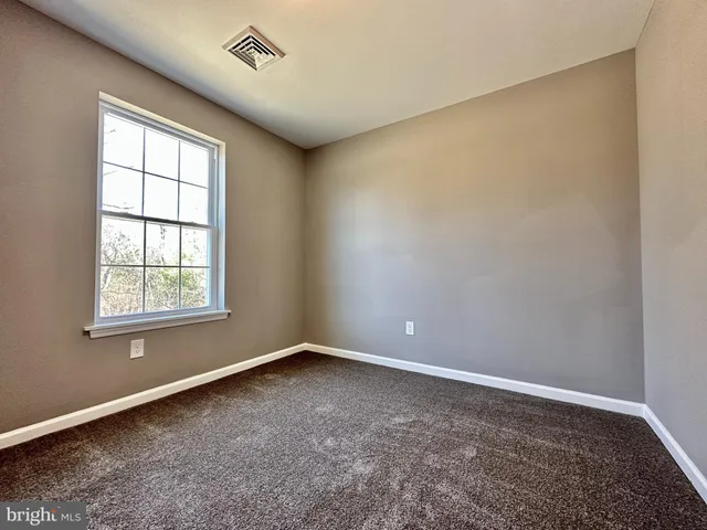 an empty room with a empty space and a window