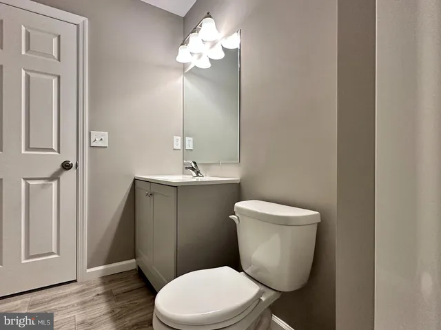 a view of an empty room with closet and a window
