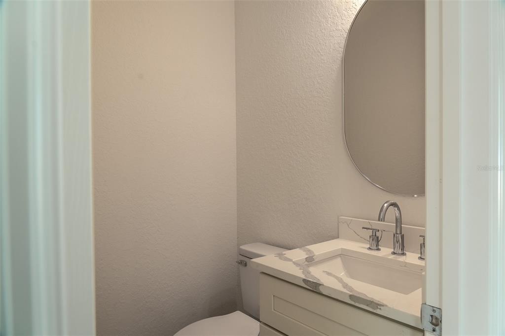 17820 Southwest 33rd Terrace Ocala, FL 34473 - Photo 14 of 35 a bathroom with a granite countertop sink and a toilet