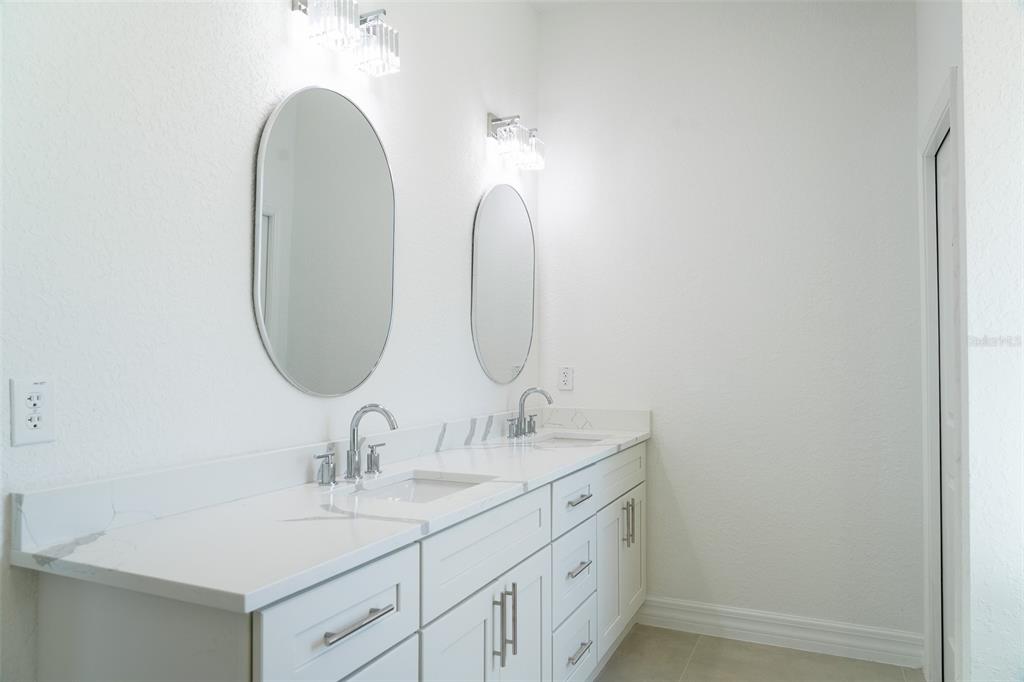 17820 Southwest 33rd Terrace Ocala, FL 34473 - Photo 18 of 35 a bathroom with a double vanity sink and a mirror