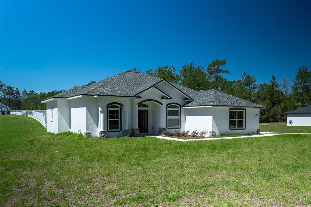 17820 Southwest 33rd Terrace Ocala, FL 34473 - Photo 3 of 35 a front view of house with yard and green space