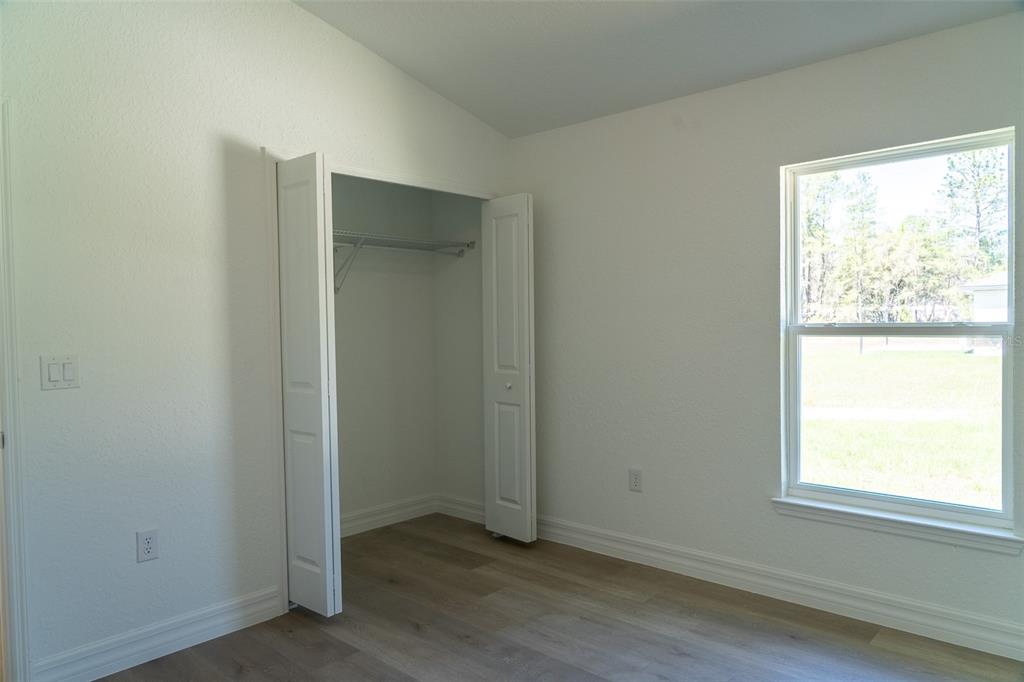 17820 Southwest 33rd Terrace Ocala, FL 34473 - Photo 31 of 35 an empty room with wooden floor and a window