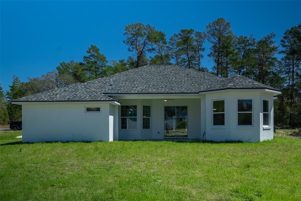 17820 Southwest 33rd Terrace Ocala, FL 34473 - Photo 5 of 35 front view of a house with a yard
