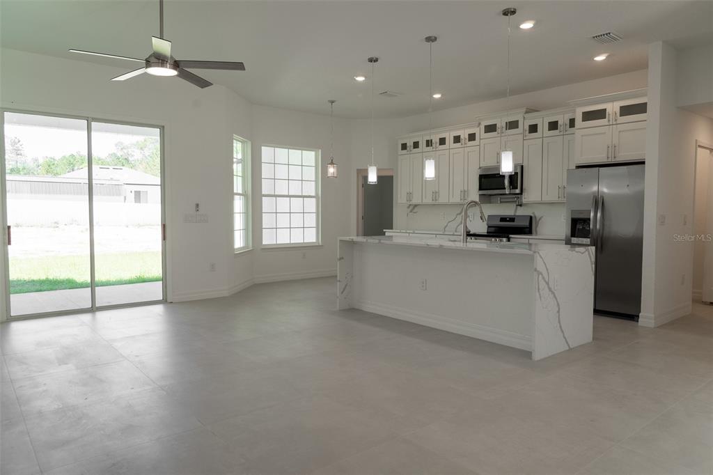 17820 Southwest 33rd Terrace Ocala, FL 34473 - Photo 7 of 35 a large white kitchen with a large window