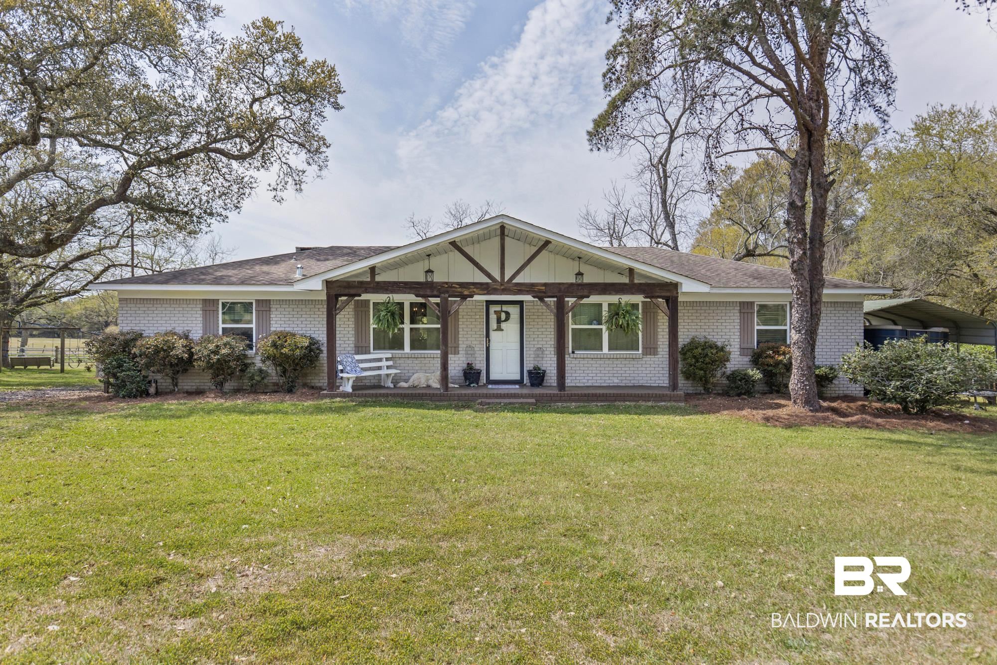 11100 Rhett McConnell Road Theodore, AL 36582 - Photo 2 of 47 Ranch-style house featuring a porch, brick siding, a front yard, and a shingled roof