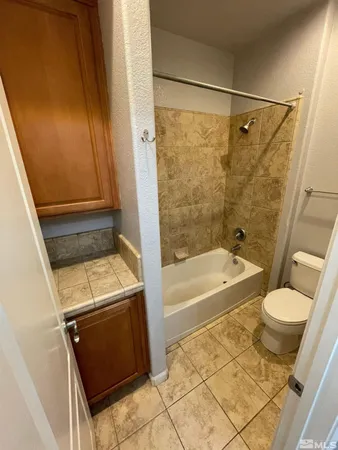 a view of empty room with kitchen and sink