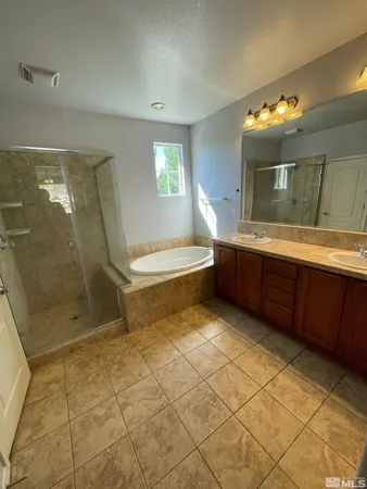 a bathroom with a double vanity sink a mirror and shower