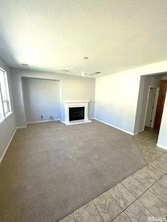 en empty room with ceiling fan and window