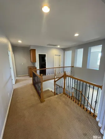 a view of a big room with windows and chandelier