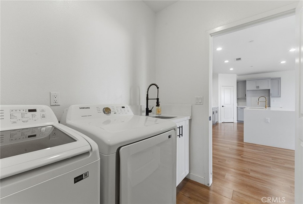 10710 Brookfield Drive Riverside, CA 92505 - Photo 12 of 32 a view of a kitchen with a sink and wooden floor