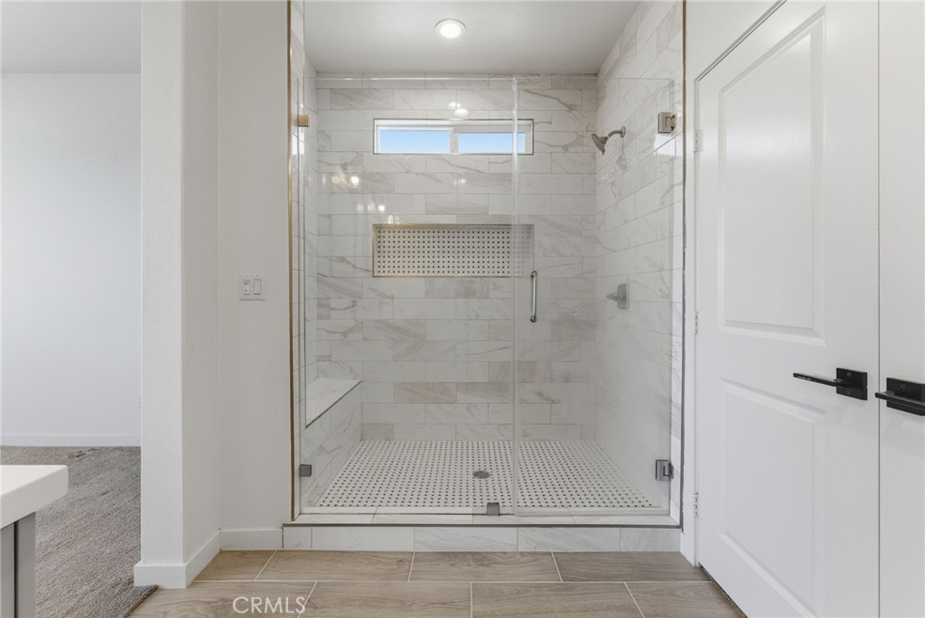 10710 Brookfield Drive Riverside, CA 92505 - Photo 18 of 32 a bathroom with a glass shower door