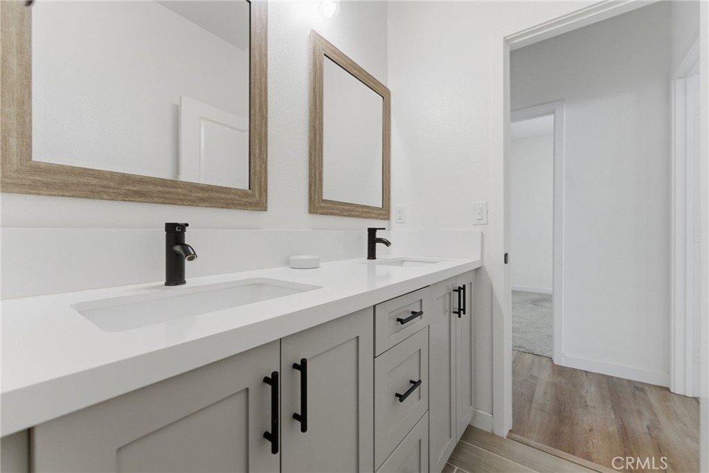 10710 Brookfield Drive Riverside, CA 92505 - Photo 21 of 32 a bathroom with a double vanity sink and a mirror