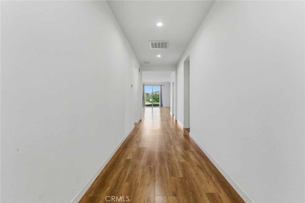 10710 Brookfield Drive Riverside, CA 92505 - Photo 3 of 32 a view of a hallway with wooden floor