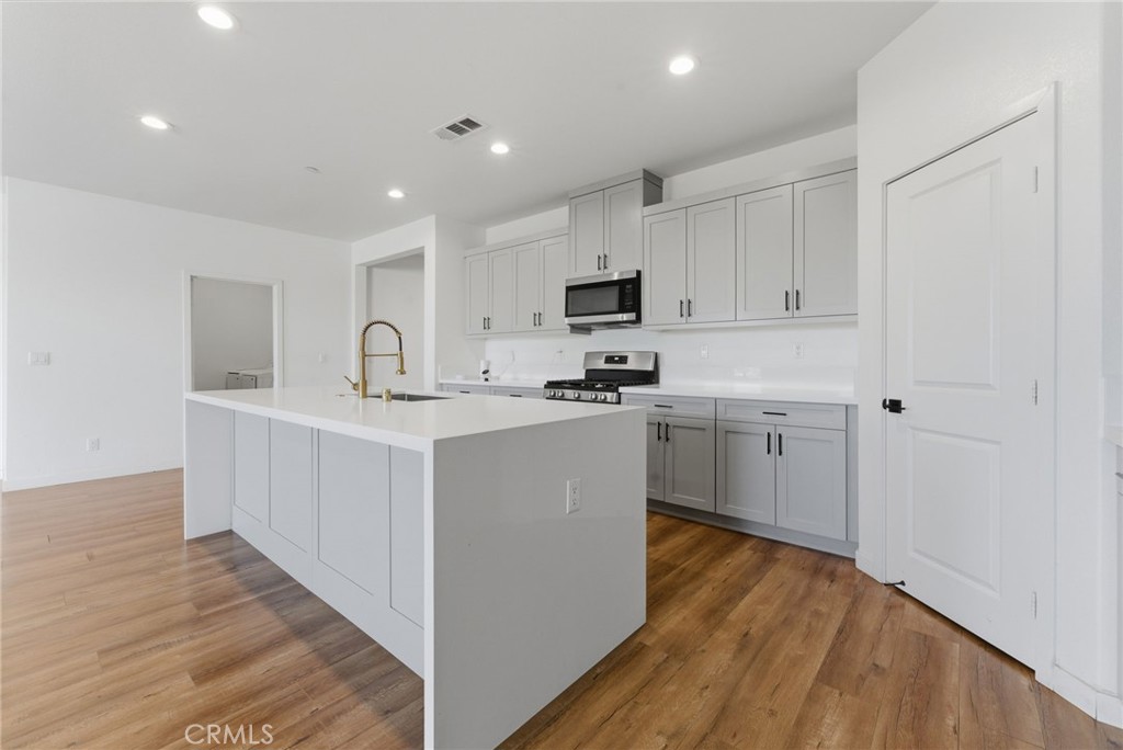 10710 Brookfield Drive Riverside, CA 92505 - Photo 9 of 32 a kitchen with kitchen island sink stove and cabinets