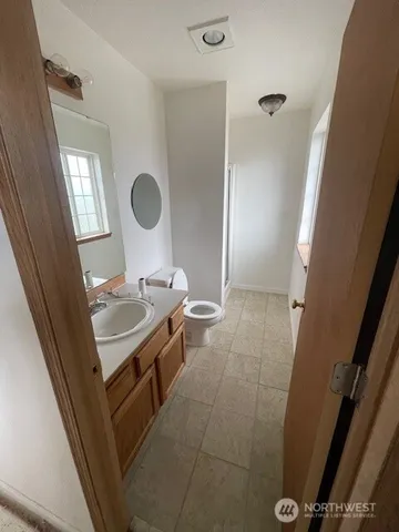 a bathroom with a sink a toilet and a mirror