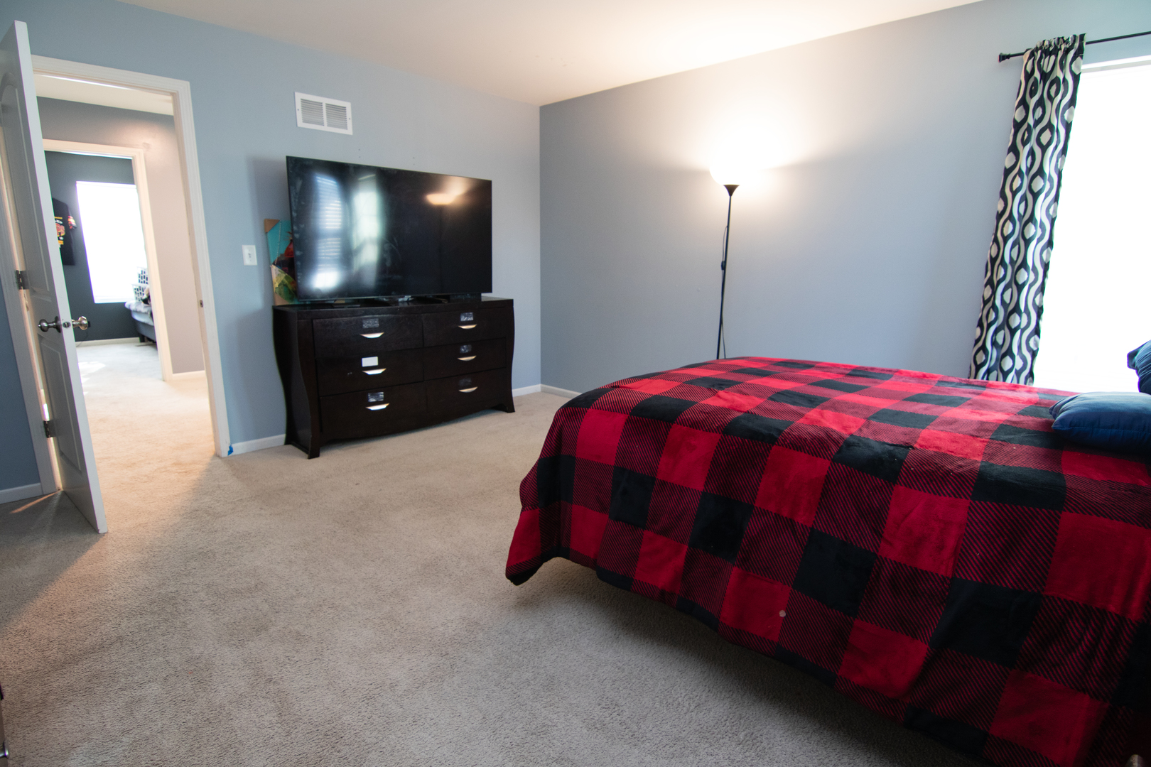 3619 Daisy Lane Elgin, IL 60124 - Photo 19 of 28 a bedroom with a bed and a flat tv screen on dresser