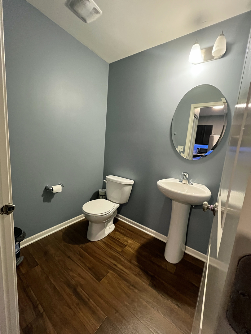 3619 Daisy Lane Elgin, IL 60124 - Photo 8 of 28 a bathroom with a toilet sink and mirror