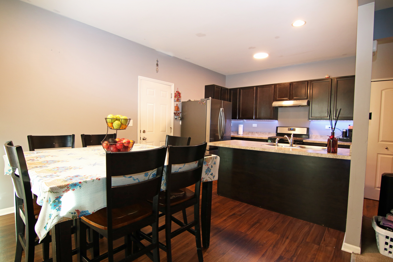 3619 Daisy Lane Elgin, IL 60124 - Photo 10 of 28 a kitchen with stainless steel appliances kitchen island granite countertop a refrigerator a stove a microwave oven a sink with island and chairs