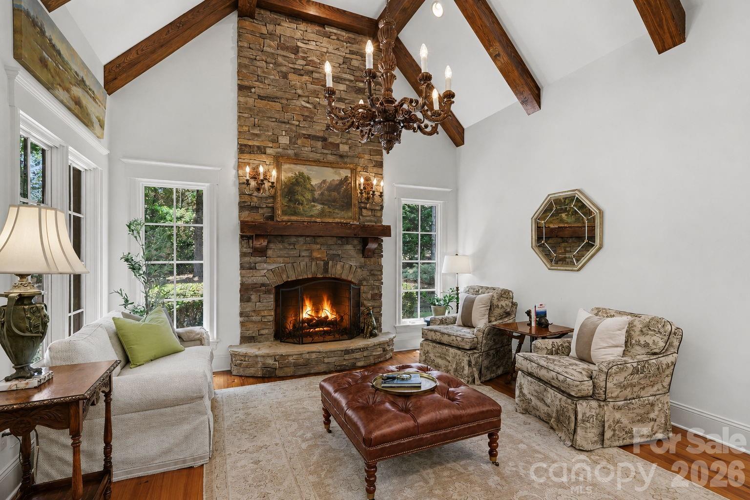 508 Hideaway Ridge Court Matthews, NC 28105 - Photo 18 of 47 a living room with furniture a chandelier and a fireplace