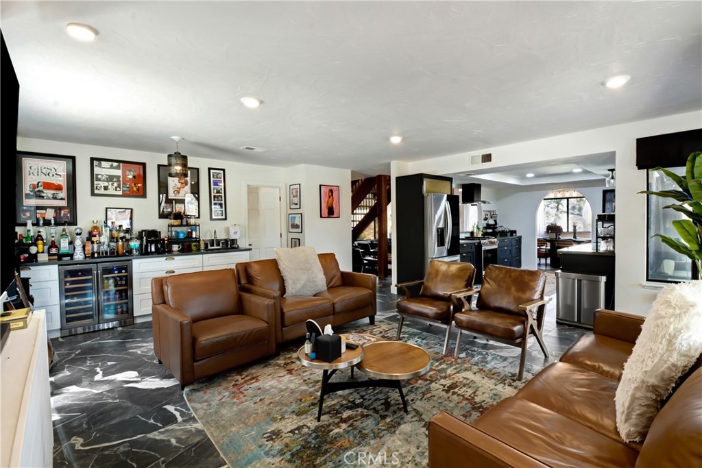 17295 Ridge Canyon Drive Riverside, CA 92506 - Photo 17 of 53 a living room with furniture kitchen view and a flat screen tv
