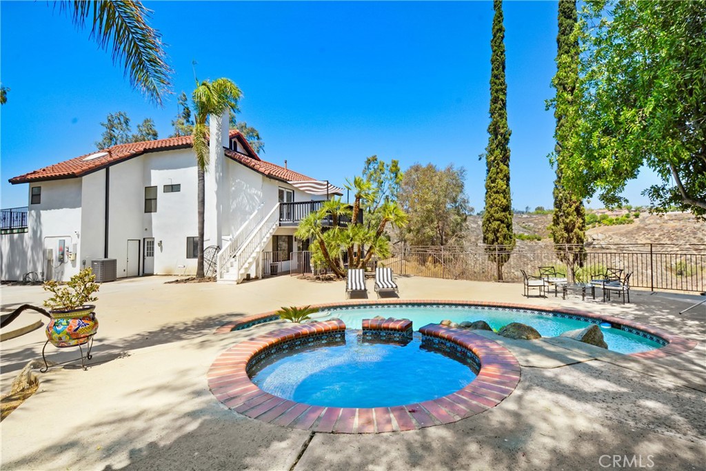 17295 Ridge Canyon Drive Riverside, CA 92506 - Photo 33 of 53 a house with swimming pool in front of it