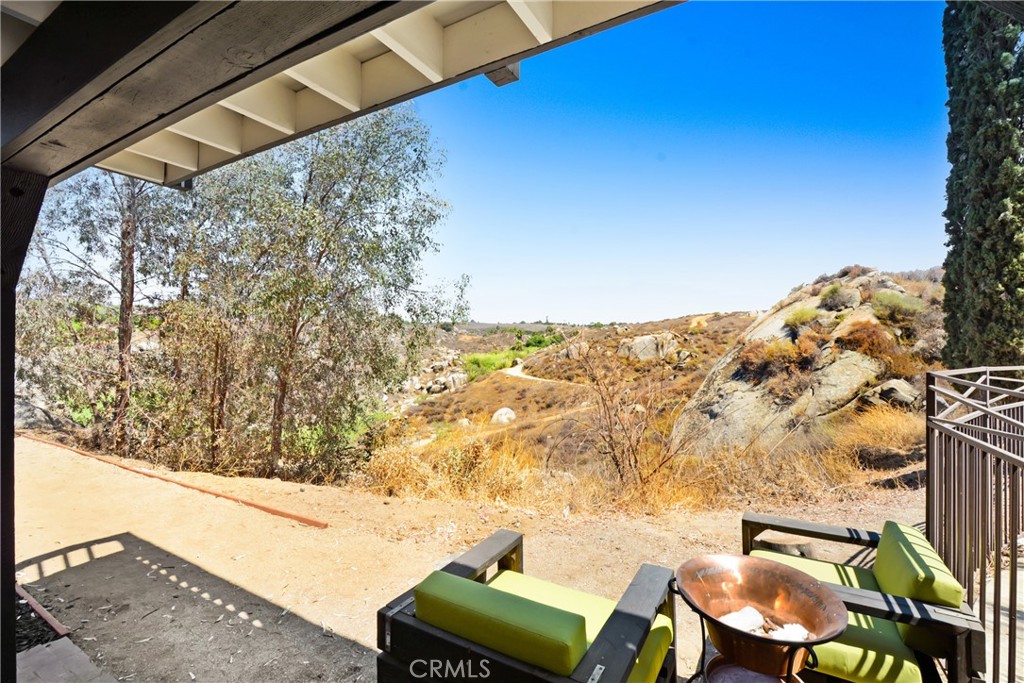 17295 Ridge Canyon Drive Riverside, CA 92506 - Photo 38 of 53 a view of a chairs and table in a backyard
