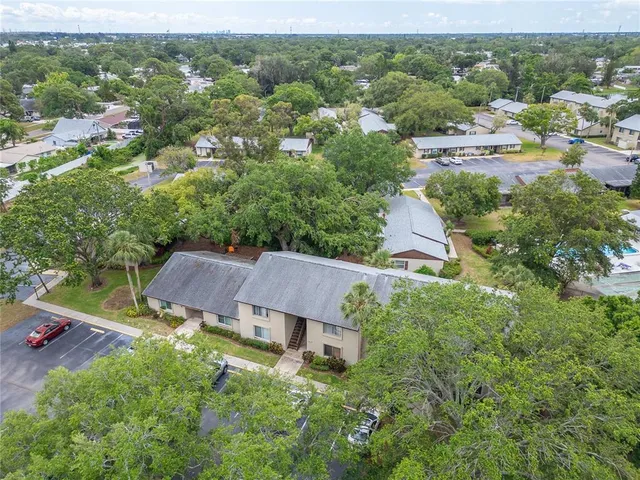 an aerial view of a house with yard