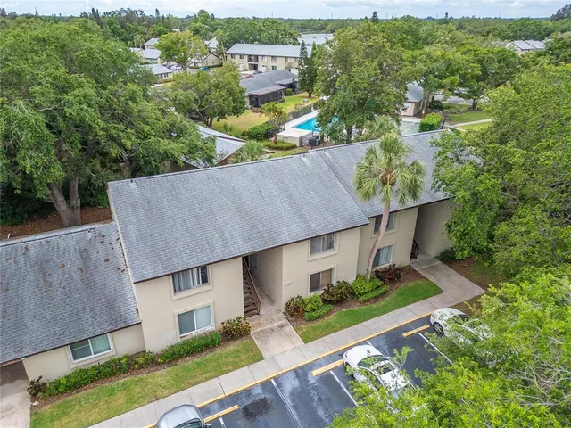an aerial view of a house with a yard basket ball court and outdoor seating