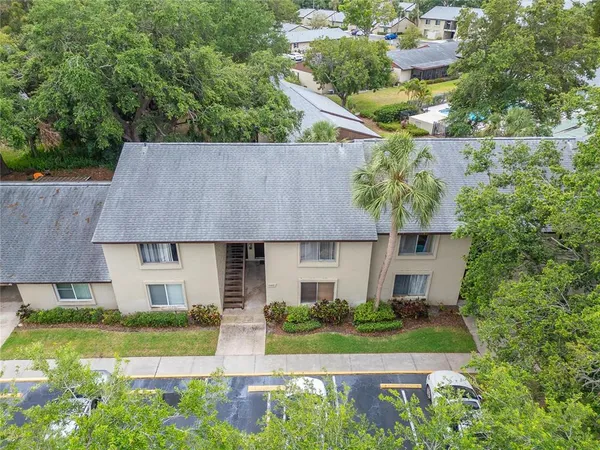 an aerial view of a house with a yard table and chairs