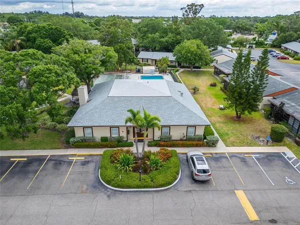 an aerial view of a house with garden space and a street view