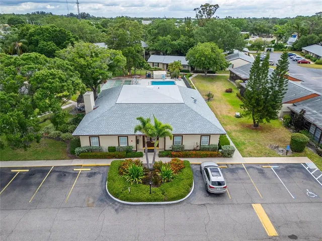 an aerial view of a house with garden space and a street view