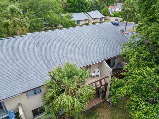 an aerial view of a house with a yard and potted plants