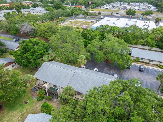 an aerial view of a house with yard and outdoor seating