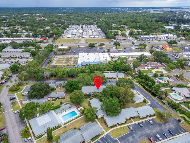 an aerial view of residential houses with outdoor space and parking