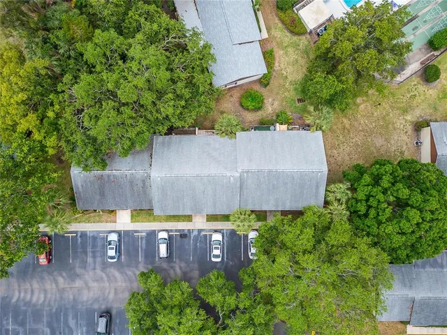 an aerial view of a house with swimming pool and garden space