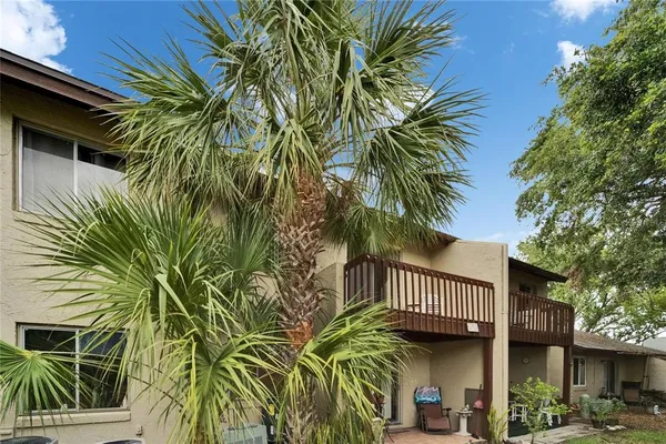a backyard of a house with table and chairs