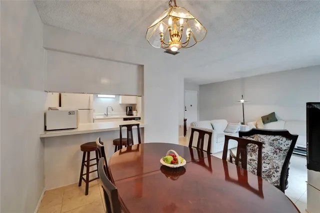 a view of a dining room with furniture and chandelier