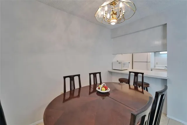 a dining room with furniture and a chandelier