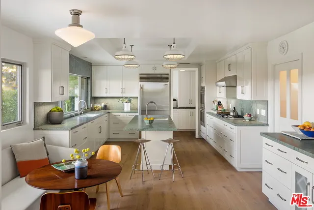 a large kitchen with a table and chairs