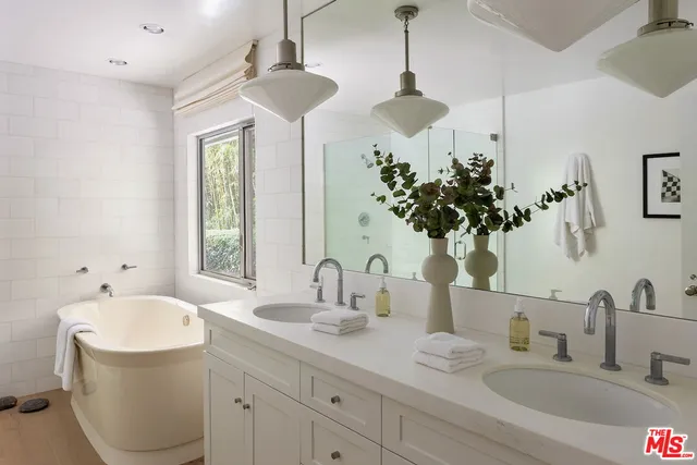 a bathroom with a double vanity sink and a bathtub