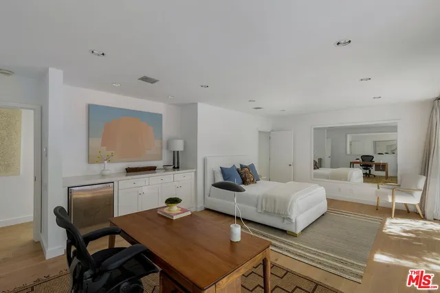 a bedroom with a bed and a desk