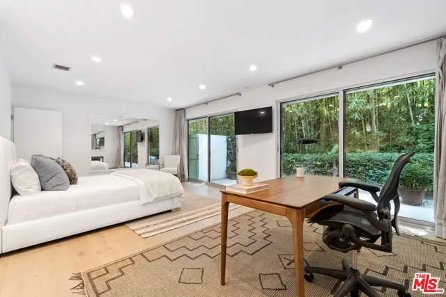 a living room with furniture and large windows