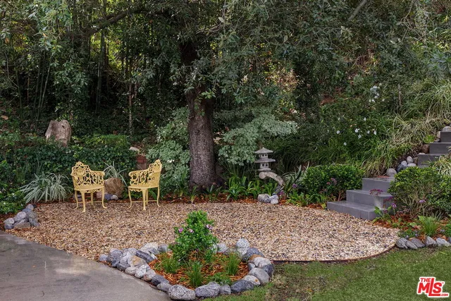 a view of a table and chairs in the garden