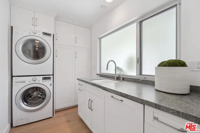 a utility room with sink dryer and washer