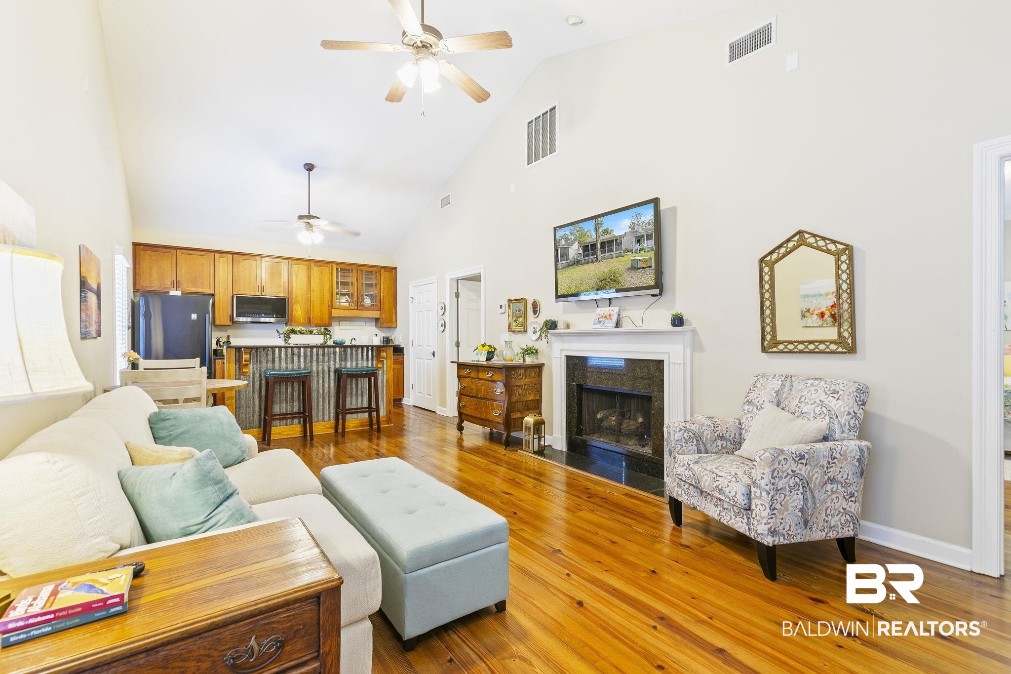 17341 Cabin Road Loxley, AL 36551 - Photo 11 of 49 Living room with ceiling fan, wood flooring, and high vaulted ceiling