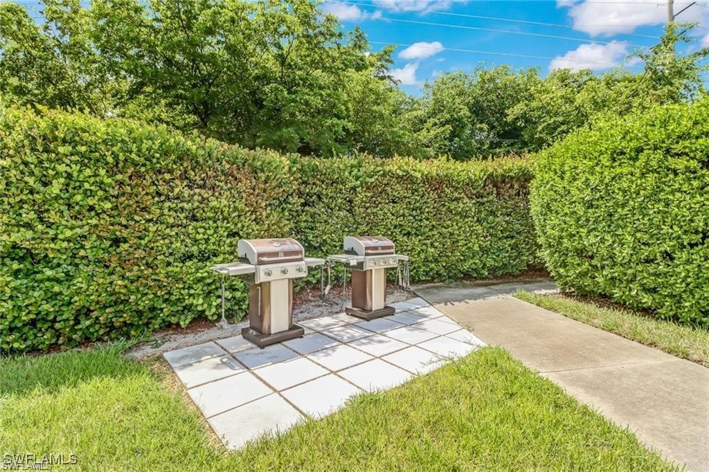 8261 Pathfinder Loop, Unit 745 Fort Myers, FL 33919 - Photo 20 of 22 a view of a garden with a fountain